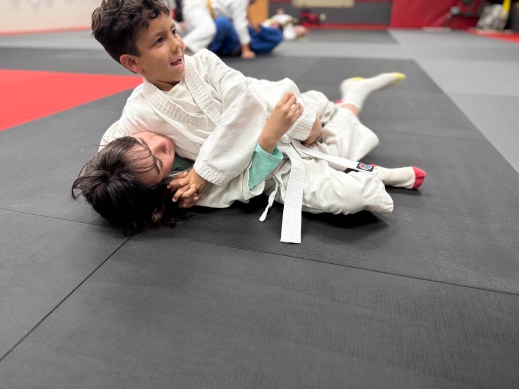 Two students work to improve their hold downs